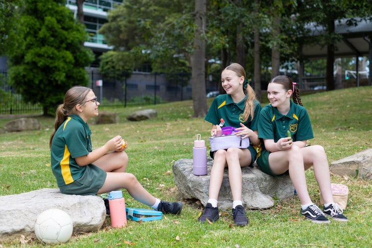 Students eating lunch in the playground.