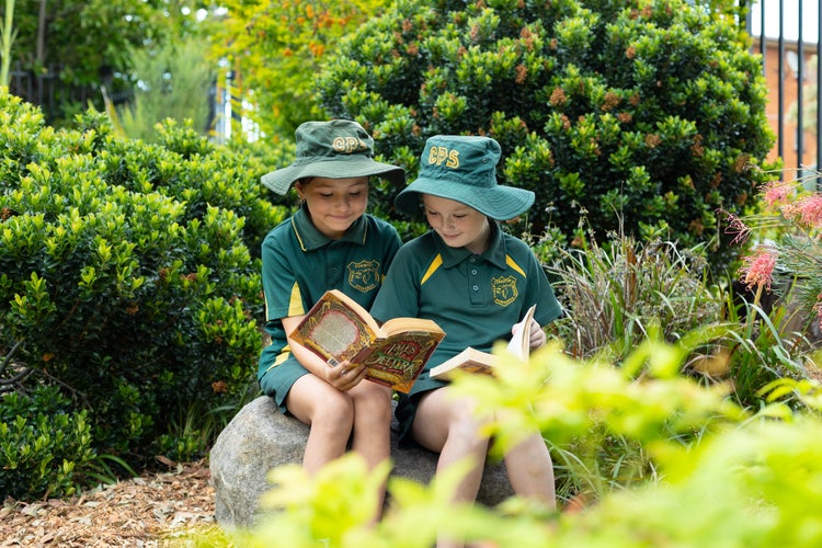 Two students reading in the garden.